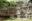 Towering face carved from limestone and intricate, decorative cubic-style decorations sits on grass